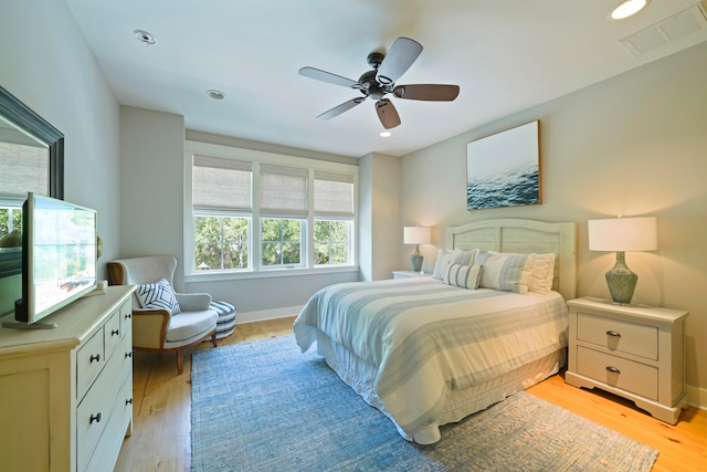 bedroom with light wood-type flooring and ceiling fan