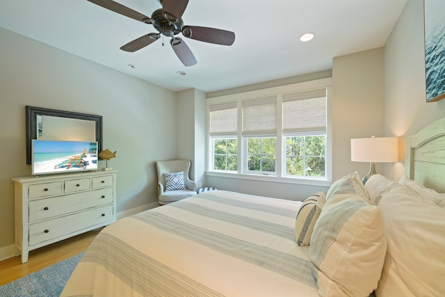 bedroom with light hardwood / wood-style floors and ceiling fan