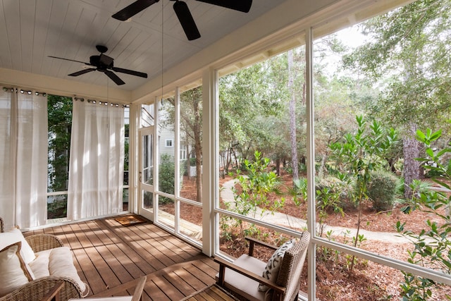 unfurnished sunroom featuring ceiling fan