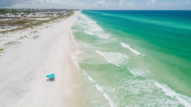 bird's eye view featuring a water view and a view of the beach