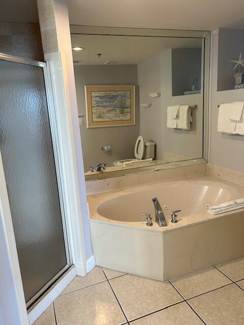 1751 Scenic Highway 98 Unit 614, Destin, FL 32541 - full bath featuring tile patterned flooring, a shower stall, and a garden tub