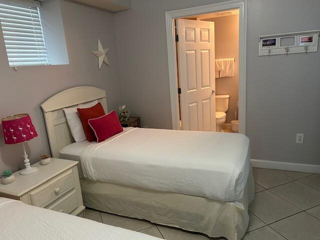 1751 Scenic Highway 98 Unit 614, Destin, FL 32541 - bedroom featuring light tile patterned flooring, ensuite bath, and baseboards