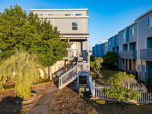 rear view of house featuring central AC unit and covered porch