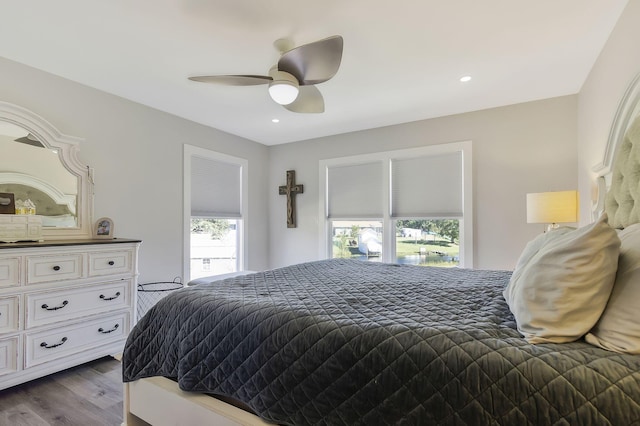 bedroom with light hardwood / wood-style floors and ceiling fan