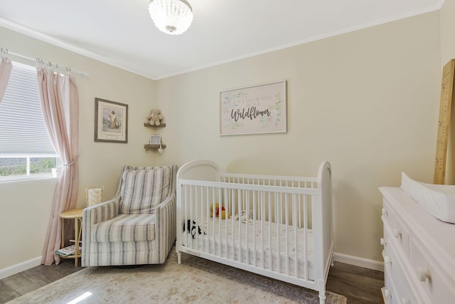 bedroom with crown molding, light hardwood / wood-style flooring, and a nursery area