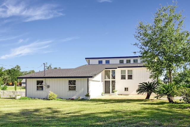 rear view of house featuring a yard