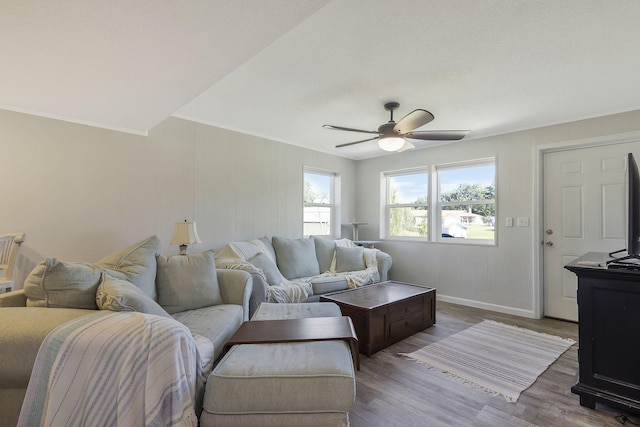 living room featuring ornamental molding, hardwood / wood-style floors, and ceiling fan