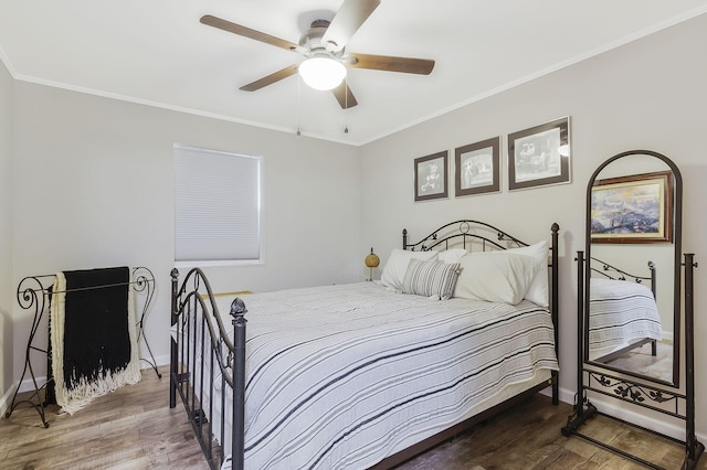 bedroom with ornamental molding, hardwood / wood-style flooring, and ceiling fan