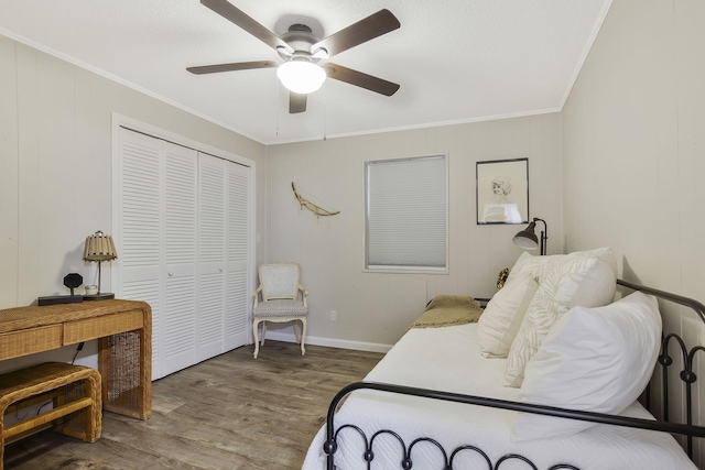 bedroom with crown molding, wood-type flooring, a closet, and ceiling fan