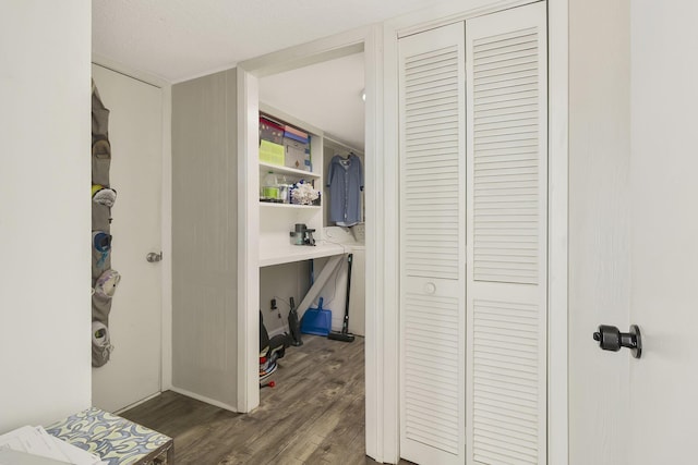 corridor featuring a textured ceiling and dark hardwood / wood-style floors