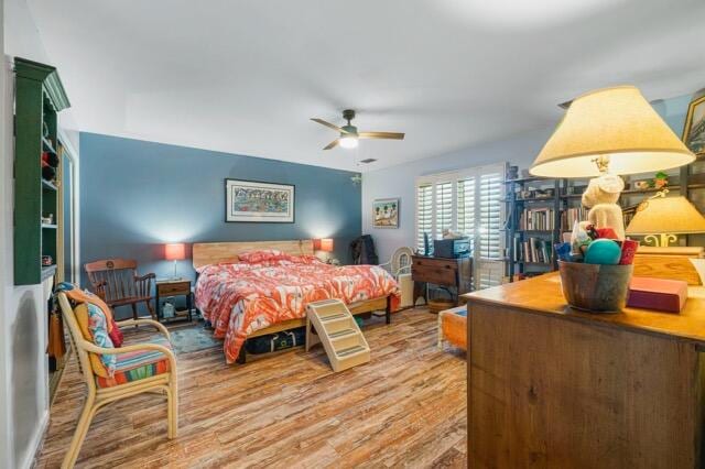 bedroom featuring wood-type flooring and ceiling fan