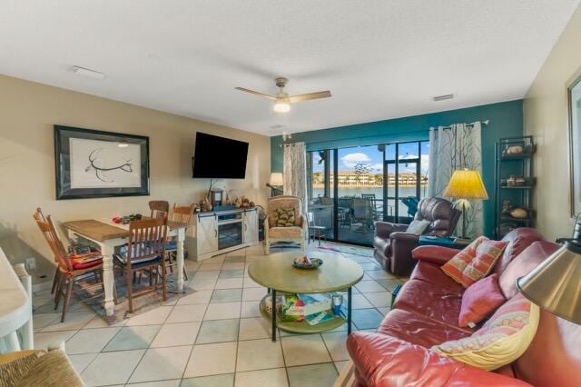 living room featuring ceiling fan and light tile patterned floors