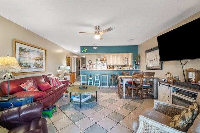 living room with light tile patterned flooring and ceiling fan