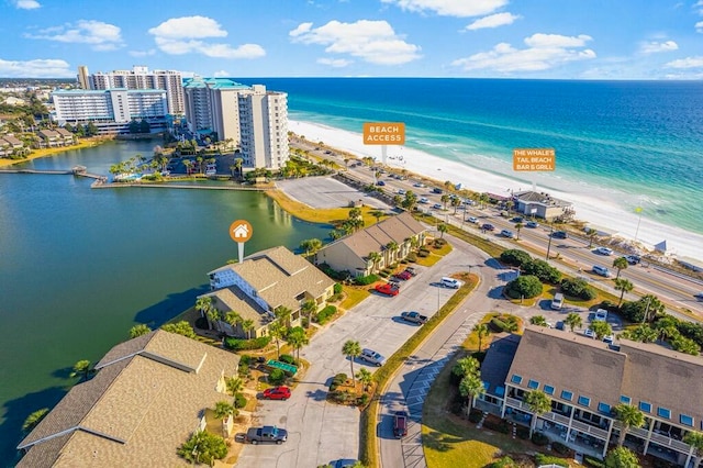 drone / aerial view featuring a water view and a beach view