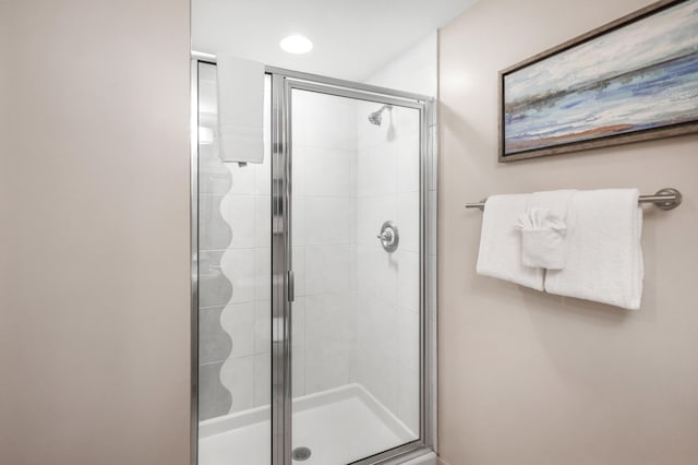 bathroom with a shower with shower door