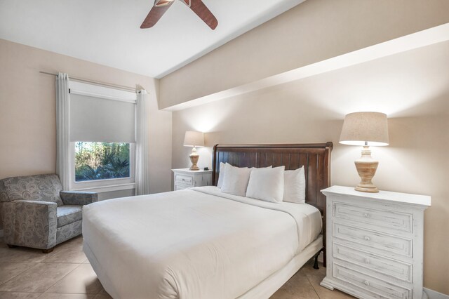 tiled bedroom featuring ceiling fan