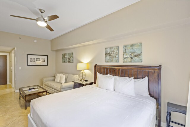 tiled bedroom with ceiling fan and baseboard heating