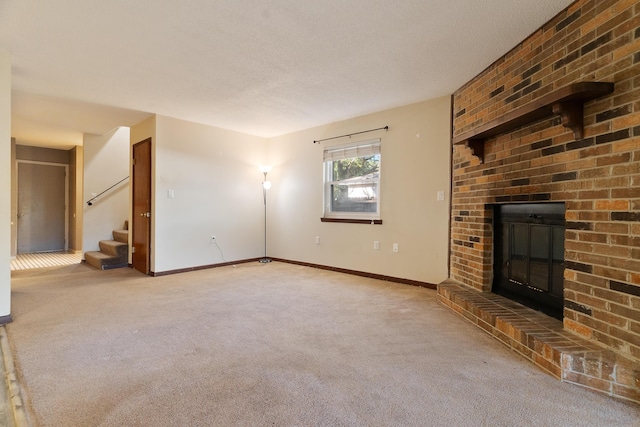 unfurnished living room featuring carpet flooring, a fireplace, and a textured ceiling