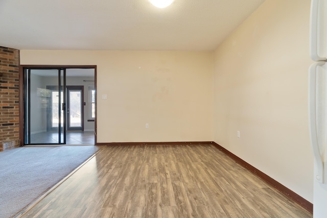 empty room with light hardwood / wood-style flooring