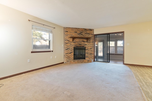 unfurnished living room with light wood-type flooring and a fireplace