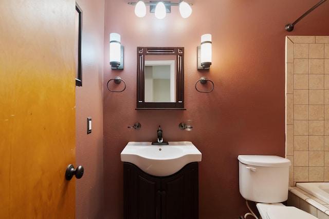 full bathroom with vanity, toilet, and tiled shower / bath