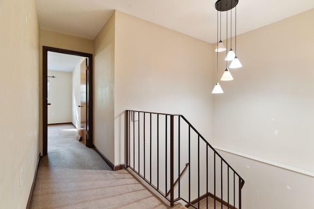 hall featuring light colored carpet