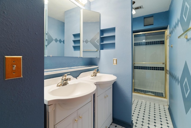 bathroom featuring tile patterned flooring, vanity, and a shower with shower door