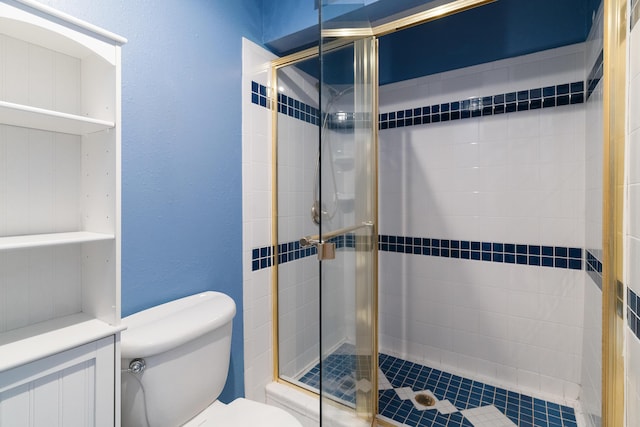 bathroom featuring an enclosed shower and toilet