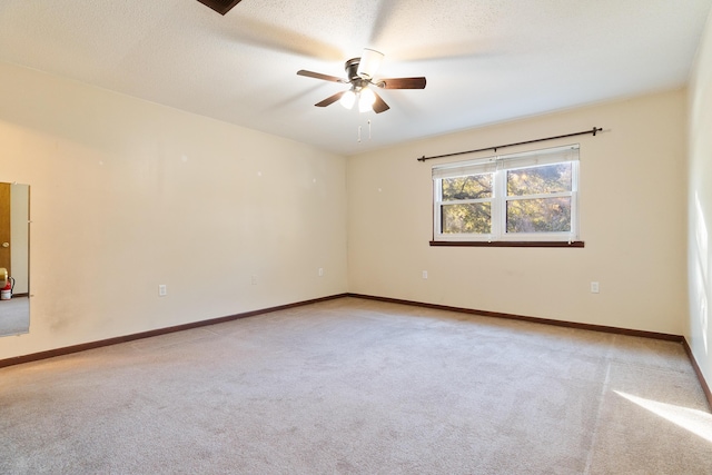 carpeted empty room with a textured ceiling and ceiling fan