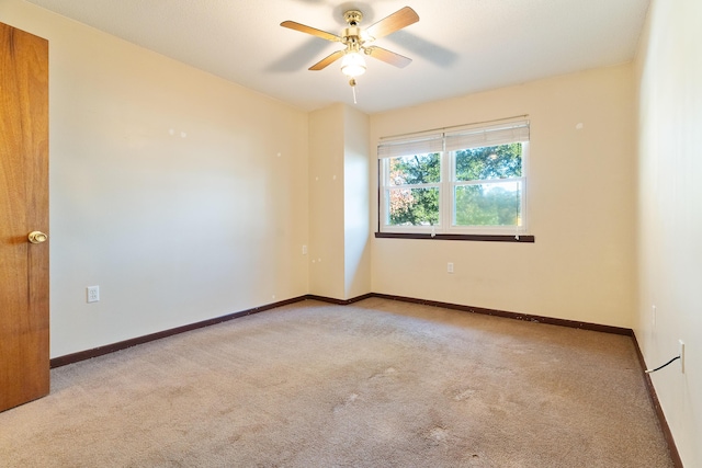 unfurnished room with ceiling fan and light colored carpet