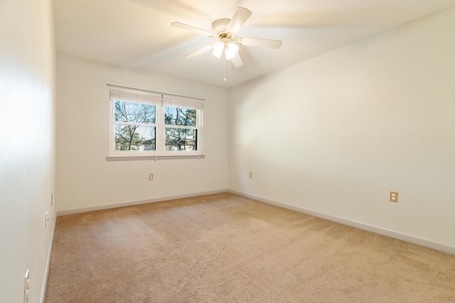 empty room with light colored carpet and ceiling fan