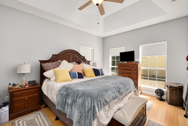 bedroom with ceiling fan and light hardwood / wood-style floors