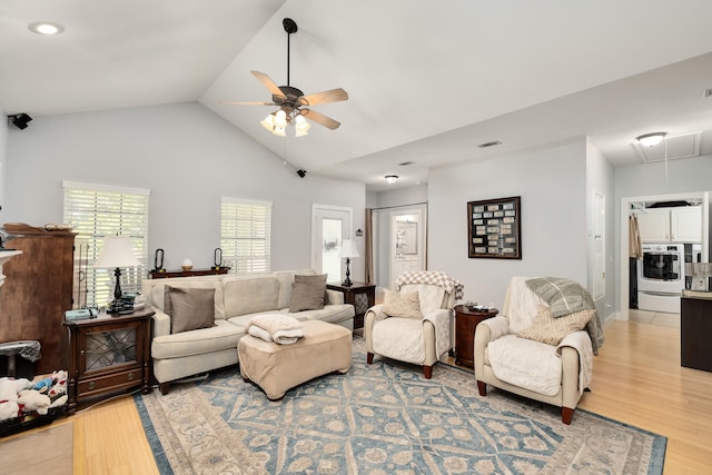 living room featuring ceiling fan, light hardwood / wood-style flooring, and high vaulted ceiling