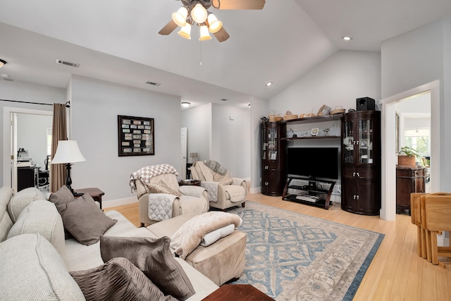 living room with vaulted ceiling, light hardwood / wood-style floors, and ceiling fan