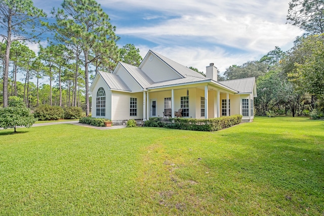 view of front of house with covered porch and a front yard