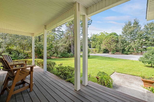 wooden deck featuring a lawn