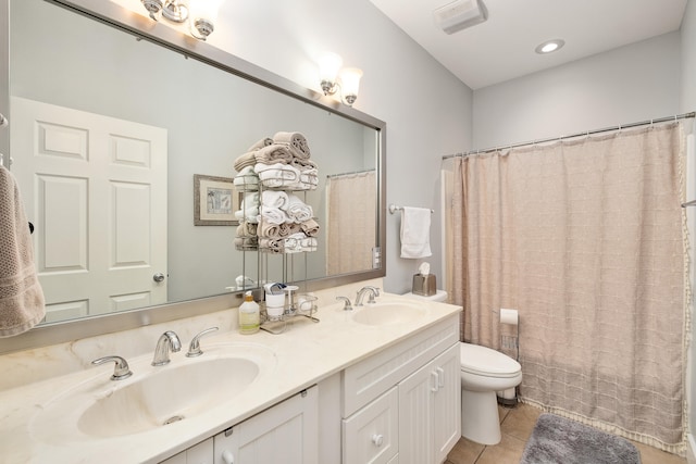 bathroom with vanity, toilet, and tile patterned floors