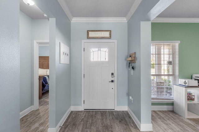 entryway featuring light hardwood / wood-style floors and crown molding