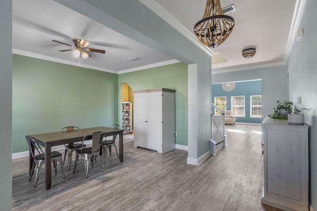 dining area with crown molding, hardwood / wood-style flooring, and ceiling fan