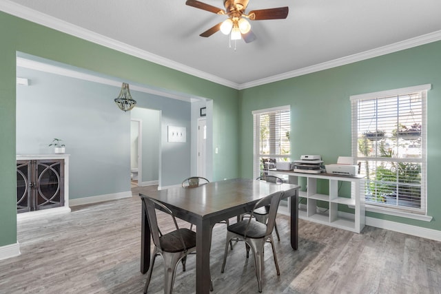 dining room with ceiling fan, ornamental molding, and hardwood / wood-style floors