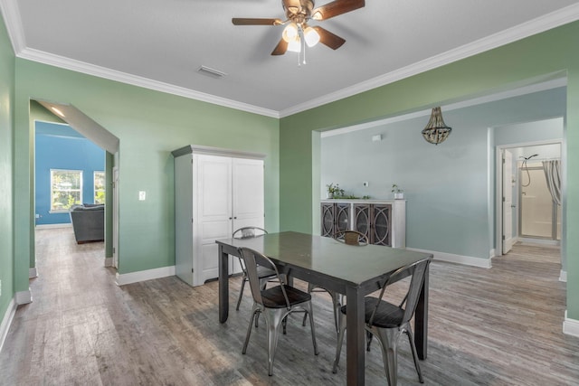 dining space featuring ceiling fan, hardwood / wood-style flooring, and ornamental molding