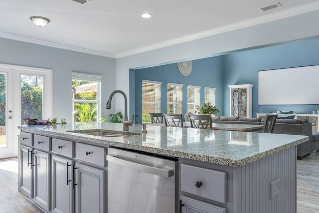 kitchen with light stone countertops, a kitchen island with sink, stainless steel dishwasher, ornamental molding, and sink