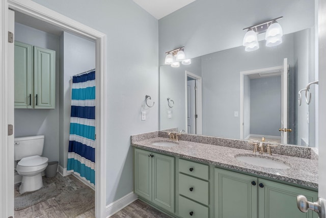 bathroom with vanity, toilet, hardwood / wood-style flooring, and walk in shower