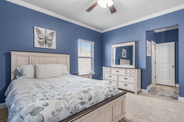 carpeted bedroom featuring ornamental molding and ceiling fan