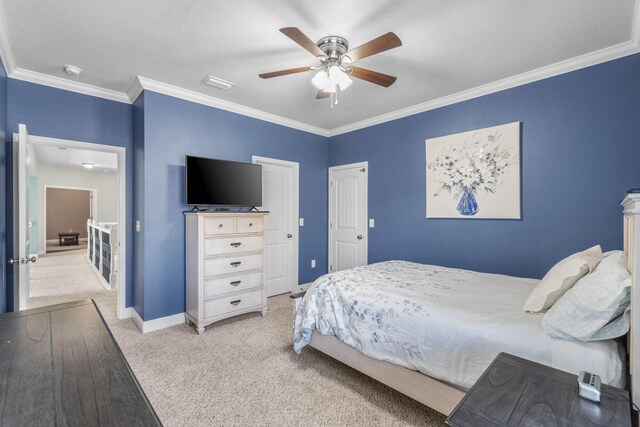 carpeted bedroom featuring crown molding, a textured ceiling, and ceiling fan