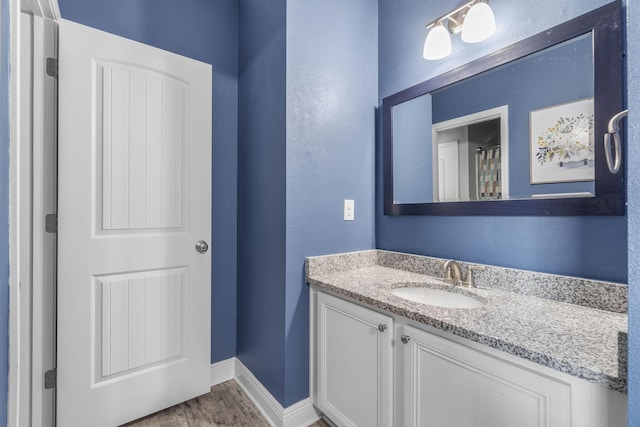 bathroom with vanity and hardwood / wood-style flooring