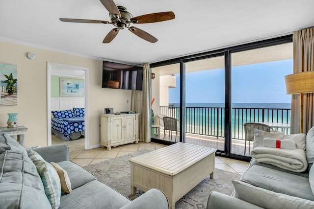 living room with ceiling fan, light tile patterned flooring, and a healthy amount of sunlight