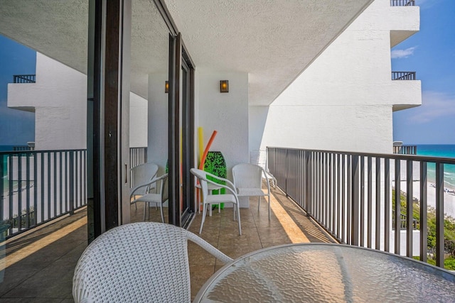 balcony with a view of the beach and a water view