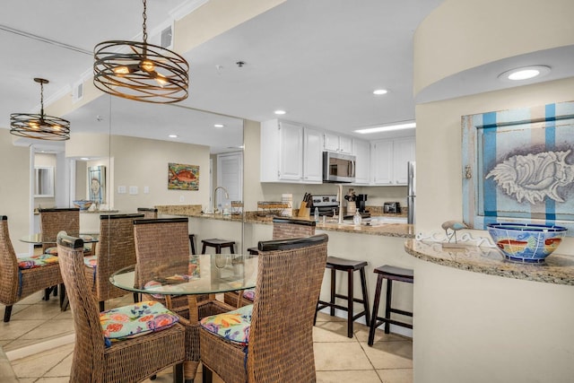 tiled dining space featuring sink