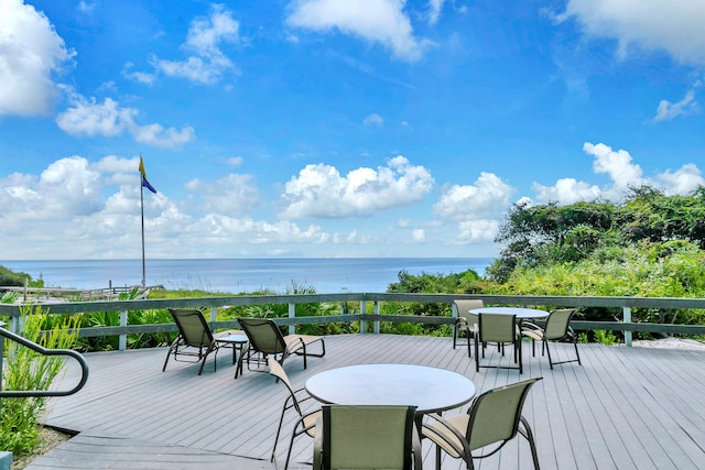 wooden terrace featuring a water view